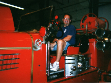 Mike on the antique firetruck he was helping to restore. He requested that he ride in it one last time to his funeral.